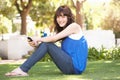 Portrait Of Teenage Girl Sitting In Park Royalty Free Stock Photo