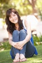 Portrait Of Teenage Girl Sitting In Park Royalty Free Stock Photo