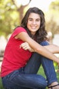 Portrait Of Teenage Girl Sitting In Park Royalty Free Stock Photo