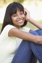 Portrait Of Teenage Girl Sitting In Park Royalty Free Stock Photo