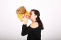 Teenage girl kissing pumpkin in yellow cap with bobbles Royalty Free Stock Photo