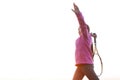 Portrait of teenage girl is training tennis skill outside court, in field at sunset. Wearing pink sweater and holding racket     . Royalty Free Stock Photo