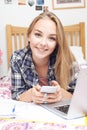 Portrait Of Teenage Girl Using Mobile Phone Whilst Doing Homework Royalty Free Stock Photo