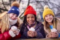 Portrait Of Teenage Girls Enjoying Hot Chocolate On Snowy Winter Walk In Countryside Together Royalty Free Stock Photo