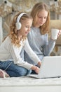 Portrait of teenage girls using laptop while sitting Royalty Free Stock Photo