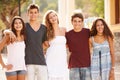 Portrait Of Teenage Group Walking Along Street Royalty Free Stock Photo