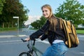 Portrait of teenage student girl with backpack on bicycle Royalty Free Stock Photo