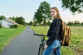 Portrait of teenage student girl with backpack on bicycle Royalty Free Stock Photo