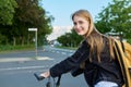 Portrait of teenage student girl with backpack on bicycle Royalty Free Stock Photo