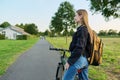 Portrait of teenage student girl with backpack on bicycle Royalty Free Stock Photo