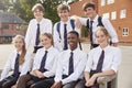 Portrait Of Teenage Students In Uniform Outside School Buildings