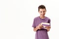 Portrait of teenaged disabled boy with cerebral palsy smiling and holding a book, posing isolated over white background Royalty Free Stock Photo