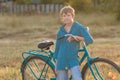 Portrait of teenager with blue bike in farm field Royalty Free Stock Photo