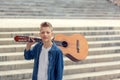 Portrait Teenager Boy with acoustic guitar in the park Royalty Free Stock Photo