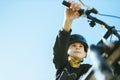 portrait of a teenager boy against the blue sky, a child on a bicycle in a black helmet to protect his head. there is a Royalty Free Stock Photo