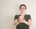 Portrait of teenager boy holding piggy bank and coin. Cute caucasian young teenager on white background. Saving Money concept. Royalty Free Stock Photo