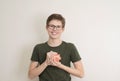 Portrait of teenager boy holding piggy bank and coin. Cute caucasian young teenager on white background. Saving Money concept. Royalty Free Stock Photo