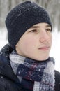 Portrait of a teenager boy wearing a blue hat and a blue checkered scarf Royalty Free Stock Photo