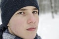 Portrait of a teenager boy wearing a blue hat and a blue checkered scarf Royalty Free Stock Photo