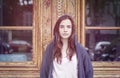 Portrait of a teenager girl in front of a old woode