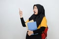 Portrait of teenager muslim female student in hijab pointing at copy space Royalty Free Stock Photo