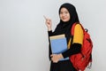 Portrait of teenager muslim female student in hijab pointing at copy space Royalty Free Stock Photo