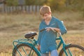 Portrait of teenager with retro bike in farm field Royalty Free Stock Photo