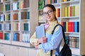 Portrait of teenager student girl looking at camera in library Royalty Free Stock Photo