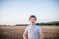 Portrait of a teenager who says something in the process of shooting. Walk in the summer through the field of mowed