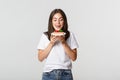 Portrait of tempted beautiful girl licking lips as looking at cake Royalty Free Stock Photo