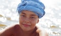 Portrait of a ten-year-old boy in a blue turban.