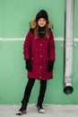 Portrait a ten-year-old girl in the winter near the wall of the house Royalty Free Stock Photo