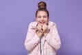 Portrait of tender adorable attractive young girl putting hands close to face, having beautiful smile, looking directly at camera Royalty Free Stock Photo