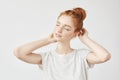 Portrait of tender redhead girl smiling with closed eyes. Royalty Free Stock Photo