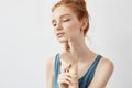 Portrait of tender redhead model posing with closed eyes. Royalty Free Stock Photo