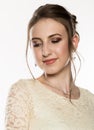 Portrait of tender young woman in cream dress on a white background. professional make-up