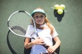 Portrait of tennis player lying on court