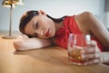 Portrait of tensed woman having a glass of whisky