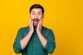 Portrait of terrified man with beard wear stylish shirt astonished staring arms on cheeks isolated on vivid yellow color Royalty Free Stock Photo