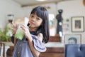 Portrait Thai Asian kid girl, aged 4 to 6 years old, is a cute and beautiful child with long hair. holding a cup of matcha green Royalty Free Stock Photo