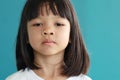 Portrait of Thai Asian kid girl with cute face, long hair, sad face, not smiling, showing thinking. Her mood is not very good. Hea Royalty Free Stock Photo