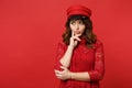 Portrait of thinkful young woman in lace dress, cap looking aside, put hand prop up on chin  on bright red Royalty Free Stock Photo