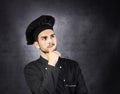 Portrait of a thinking chef cooker in black uniform. Royalty Free Stock Photo