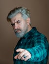 Portrait of thinking stylish young man. Handsome man with a beard. Portrait of businessman on grey background.