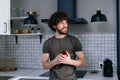 Portrait of thinking young man holding box with wedding ring and dreaming looking out window in kitchen at home. Royalty Free Stock Photo