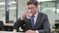 Portrait of Thirsty Middle Aged Businessman Drinking Water Royalty Free Stock Photo