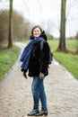 Portrait of a thirty year old beautiful woman standing in front of a cobblestone countryroad Royalty Free Stock Photo