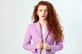 Portrait of thoughtful beautiful business woman with red - brown hair and makeup in pink suit. thinking and looking away Royalty Free Stock Photo