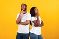 Black man and woman thinking on yellow background Royalty Free Stock Photo