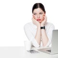 Portrait of thoughtful brunette businesswoman in white shirt sitting with laptop, touching her face, looking away, confused and Royalty Free Stock Photo